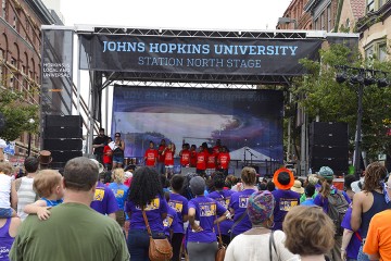 student perform on the Johns Hopkins University stage