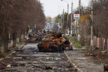 A destroyed tank and debris litters streets in Bucha after the Russian invasion of Ukraine