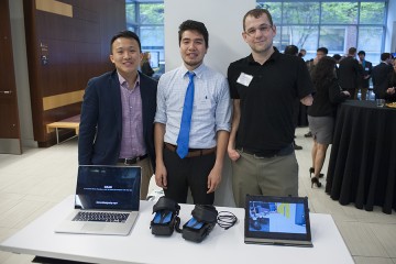 the three GEAR teammates pose with their design and two computers