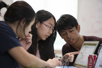 Students work together on a computer