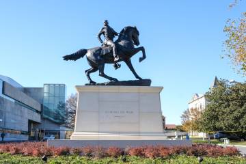 Photograph of a statue of a Black man astride a horse in the style of Confederate memorial statues