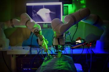 Photo of autonomous robot performing a surgery in a dark room