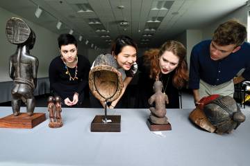 Students examine African artifacts