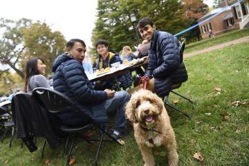 A family brings their dog to Family Weekend