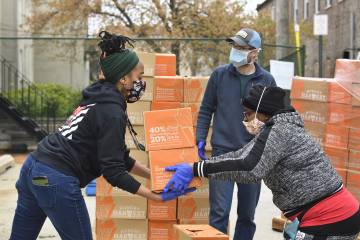 Volunteers sort donated boxed food