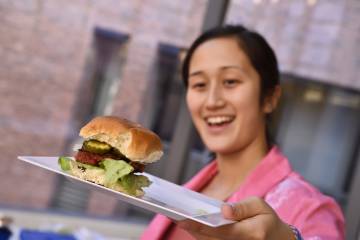 A student displays her burger slider