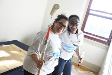 Volunteers paint a bedroom
