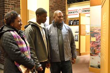 A family views an exhibit at the Reginald F Lewis Museum