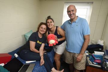 Andrea Guillen and her parents in her room in AMR II