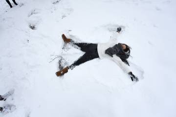 A female students makes a snow angel