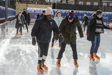 Small groups ice skate together