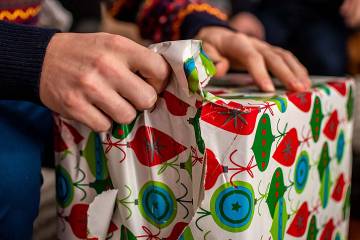 Man’s hands unwrapping a gift