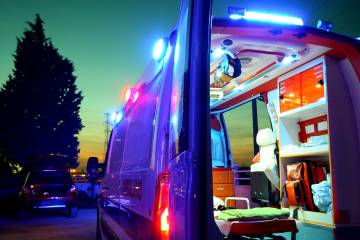 An ambulance stands open in the early hours of the morning