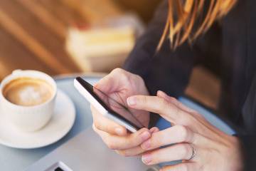 Woman’s hands using an app on a mobile phone