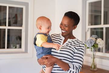 Middle-aged woman holding toddler