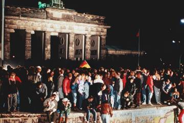 East Berliners scale the Berlin Wall at night