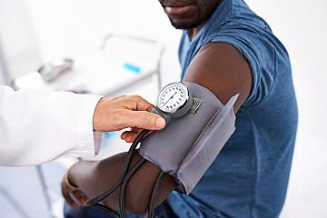 Man is having is blood pressure checked.