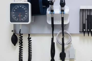 Blood pressure cuff hanging on doctor's office wall