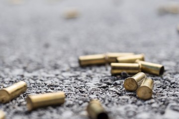 Bullet casings lie on a street