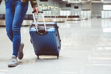 Woman pulling luggage in airport
