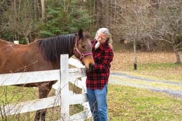 Carey Priebe grooms a horse
