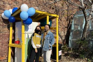 Baltimore Community Fridge co-founders Clara Leverenz and Abbey Franklin posing in front of the fridge on its opening day, Nov. 14, 2020.