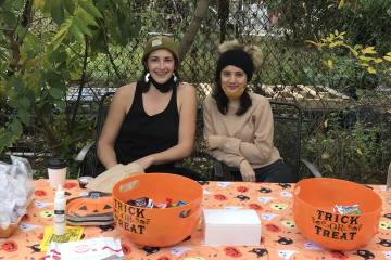 Clara Leverenz (right) and Baltimore Community Fridge organizer Christina Calhoun hosting a Halloween 2021 pop-up at the fridge
