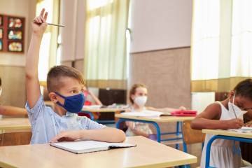 Masked children in a classroom