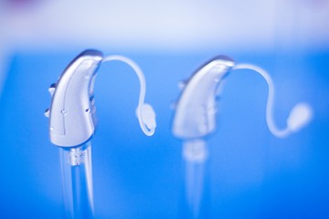 Digital hearing aids against blue background