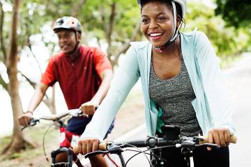 Young woan and man riding bikes in the countryside