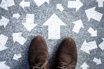 Feet standing on floor with arrows pointing in many directions