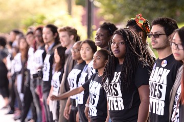 A row of students, faculty, and staff link arms at the Black Lives Matter solidarity demonstration