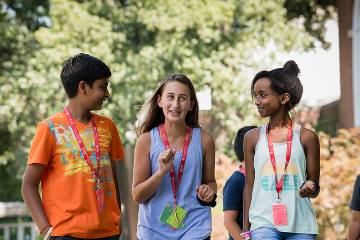 Three smiling adolescents wearing CTY lanyards