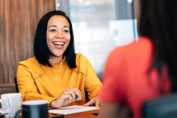 Smiling woman talking with a customer