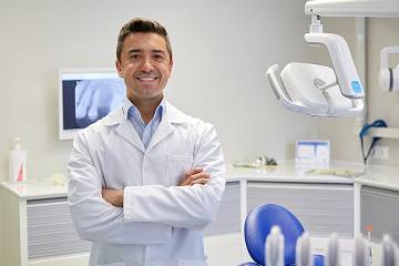 Smiling male dentist in office