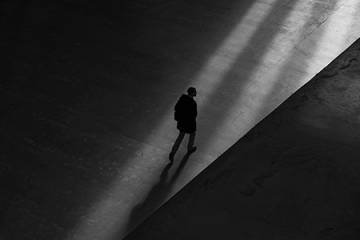 Shadowy figure walks in the shadows