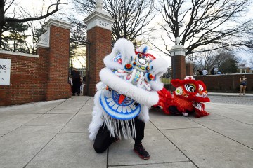 Two Chinese dragons, one white and one red, by the East Gate of Johns Hopkins University's Homewood campus
