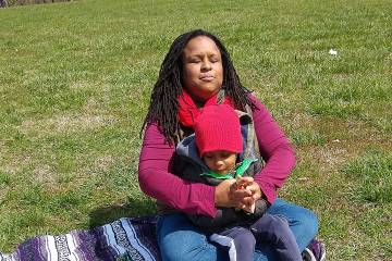 Essence Pierce and her son Joshua relax on the grounds of Lake Montebello near their home in Ednor Gardens.