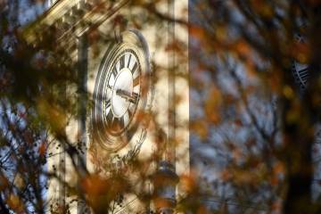 Gilman clock tower clock face with fall leaves