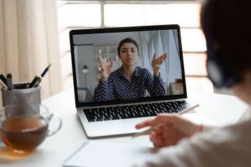 Female manager on computer screen talking with her employee