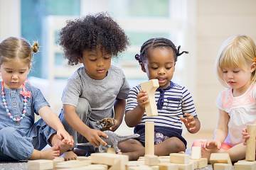 Toddlers playing with building blocks
