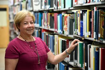 Liz Mengel, associate director of Collections & Academic Services, in the stacks at the Milton S. Eisenhower Library at Homewood.