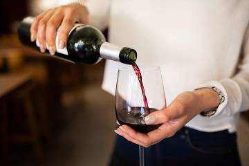 Woman pouring a glass of red wine