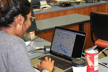 A student looks at points plotted on a Baltimore City map