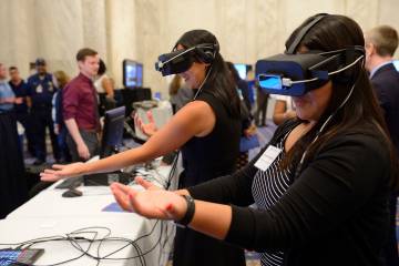 Women wear virtual reality headsets