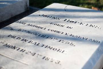 The tombstone marking the birth of Johns Hopkins on May 19, 1795, and his death on Dec. 24, 1873.