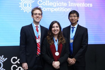 Three Hopkins team members pose with silver medals