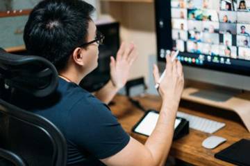 Person working from home and looking at a computer screen