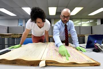 A Johns Hopkins graduate student looks over bounds records with Professor Lawrence Jackson