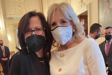 Elizabeth Jaffee and First Lady Jill Biden, both wearing masks, pose for a photo together at the the White House